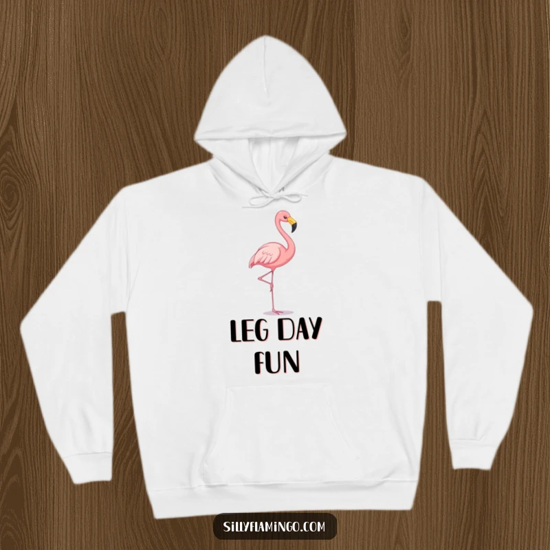 Funny flamingo hoodie depicting a cheerful flamingo balancing on one leg, perfect for cozying up with a smile.
