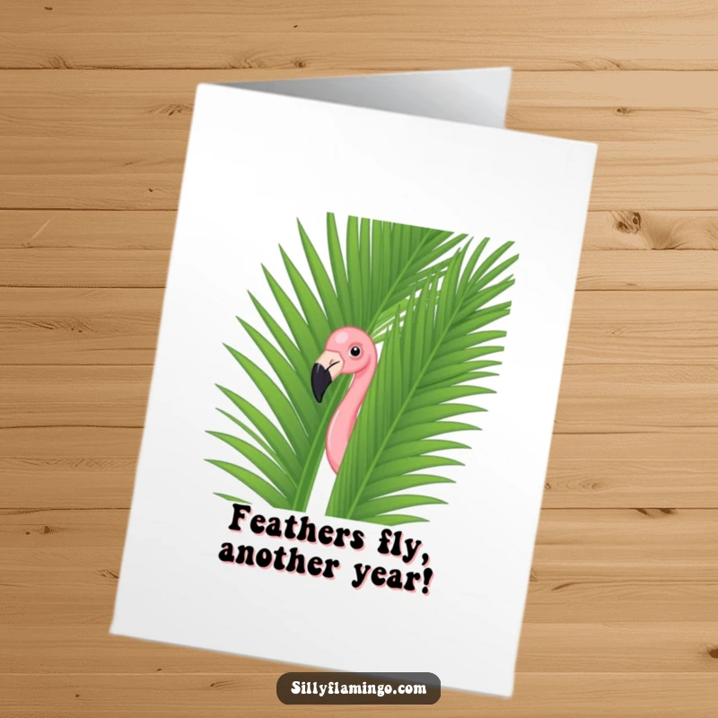 Funny Free Printable Flamingo Birthday Card: A sneaky flamingo pops out from behind a lush palm leaf, ready to deliver birthday wishes.