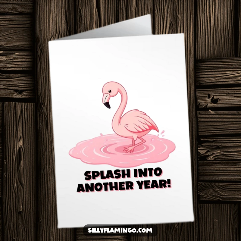 Free Printable Birthday Card: A joyful flamingo playfully splashes in pink water, creating a fun birthday scene.