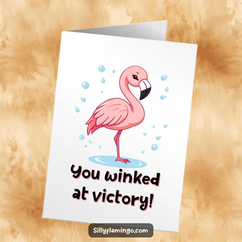 Free Printable Congratulations Card: A flamingo with a cheerful wink surrounded by glittering water drops. Fun downloadable celebration.