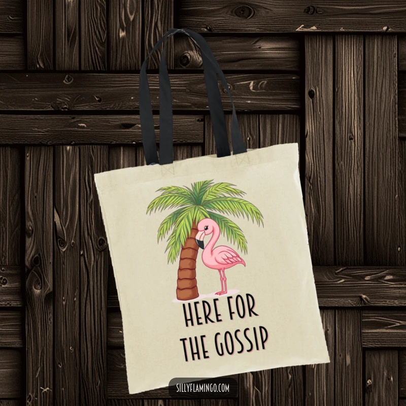 Funny tote bag featuring a cute pink flamingo peeking from behind a palm tree, ideal for carrying beach essentials with humor.